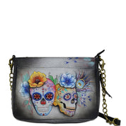 Anuschka style 636, handpainted Compact Crossbody With Front Pocket. Calaveras de Azucar Painted in Grey Color. Featuring front full length pocket with magnetic button and extended zippered gusset.