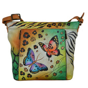 Anna by Anuschka style 7029, handpainted Travel Organizer. Animal Butterfly painting in tan color. Featuring inside full length wall pocket, cell pocket and credit card holders, adjustable crossbody handle, Built-in organizer, Fits tablet, Fits E-Reader.