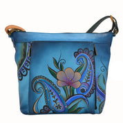 Anna by Anuschka style 7029, handpainted Travel Organizer. Denim Paisley Floral painting in blue color. Featuring inside full length wall pocket, cell pocket and credit card holders, adjustable crossbody handle, Built-in organizer, Fits tablet, Fits E-Reader.