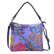 Anna by Anuschka style 8188, handpainted Convertible Shoulder Bag. Floral Safari Purple painting in purple color. Featuring inside one zippered wall pocket, one open wall pocket, two multipurpose pockets, Fits tablet, Fits E-Reader, Fits Laptop, Removable strap.