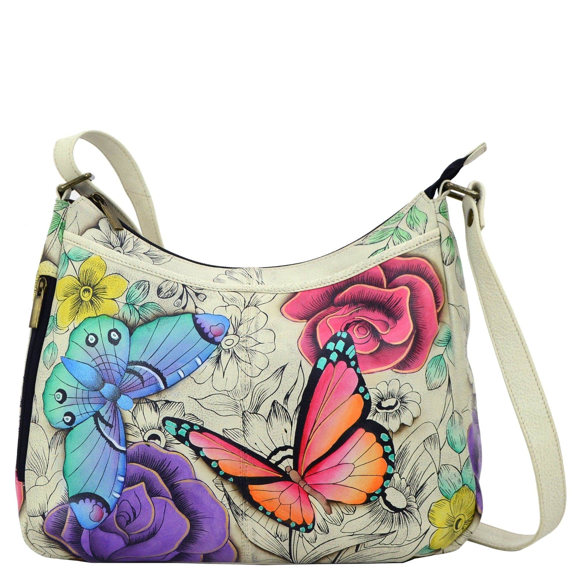 Anna by Anuschka style 8241, handpainted Cross Body Hobo. Floral Paradise painting in white color. Featuring two vertical zippered pocket at gusset, Fits E-Reader, Fits tablet, Fits Laptop.