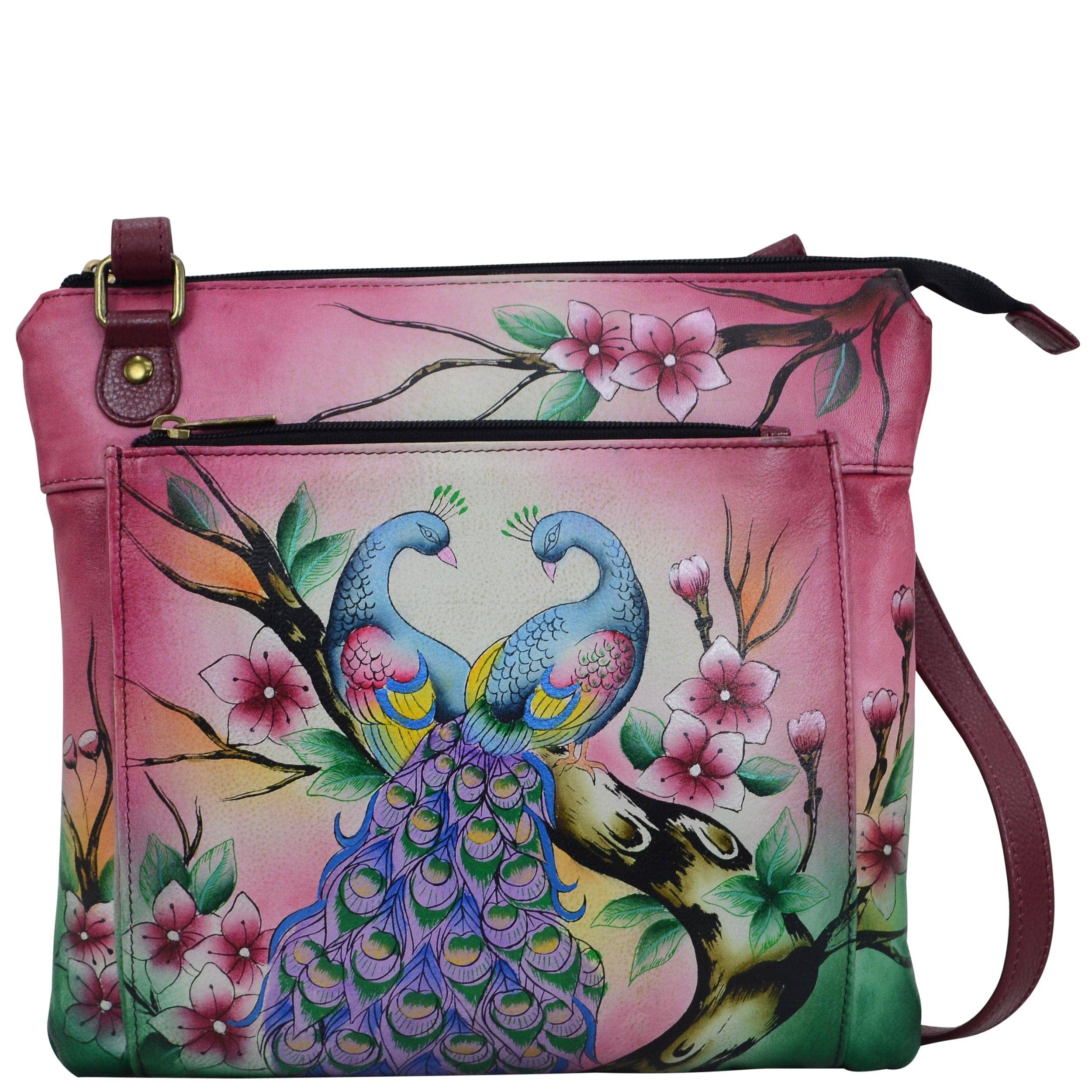Anna by Anuschka style 8285, handpainted Multi Pocket Crossbody. Peacock Paradise painting in pink/peach color. Inside zippered wall pocket, open wall pocket, two multipurpose pockets, Fits E-Reader, Fits tablet.