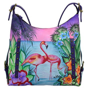 Anna by Anuschka style 8311, handpainted Shoulder Hobo. Tropical Flamingos painting in purple color. Featuring inside zippered wall pocket, two multipurpose pockets, Fits E-Reader, Fits tablet.