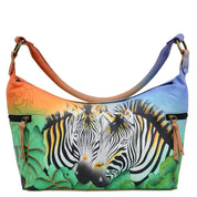 Anna by Anuschka style 8320, handpainted Medium East West Hobo. Zebra Safari painting in multi color. Featuring inside zippered wall pocket, two multipurpose pockets and two zippered side pockets.