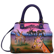 Anna by Anuschka style 8392, handpainted Multi Compartment Satchel. Serengeti Sunset painting in pink/peach color. Featuring two compartments with magnetic snap button, inside one full length zippered compartment and full length zippered wall pocket, two multipurpose pockets with gusset.