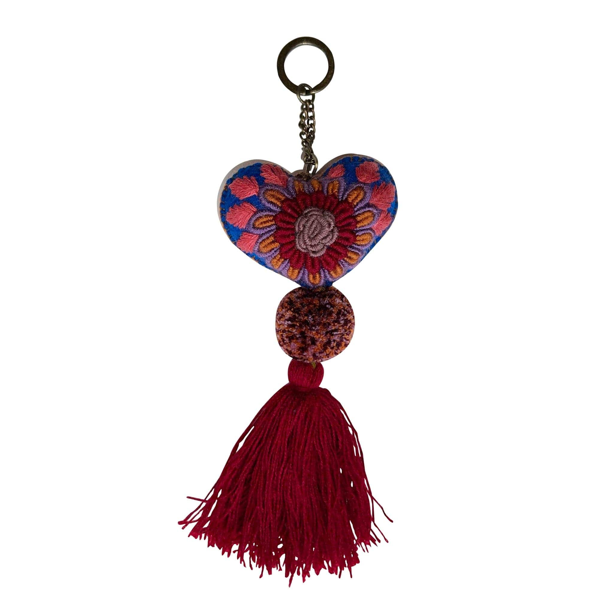 Anuschka style 12007, Hand Woven Charms from Oaxaca, Mexico. The handmade felt heart Keycharms have a beautiful embroidered floral design adorned with pompoms and tassels, from Oaxaca, Mexico.