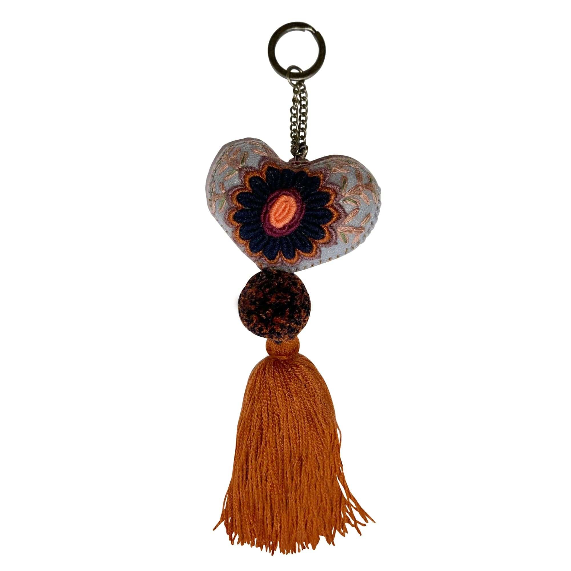 Anuschka style 12007, Hand Woven Charms from Oaxaca, Mexico. The handmade felt heart Keycharms have a beautiful embroidered floral design adorned with pompoms and tassels, from Oaxaca, Mexico.