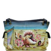 Anna by Anuschka style 8336, handpainted East West Shoulder Bag. Caribbean Dream painting in blue color. Faeturing inside one zippered wall pocket, two multipurpose pockets and two side pockets with magnetic flap.